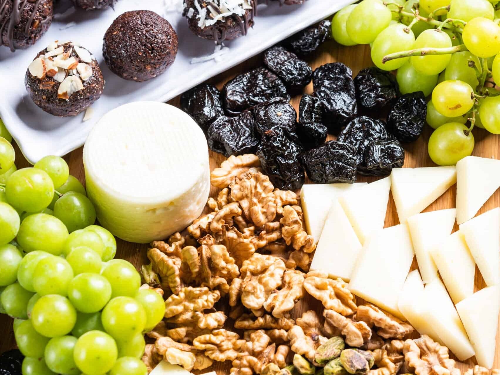 California prune snack tray with grapes, prunes, nuts and truffles