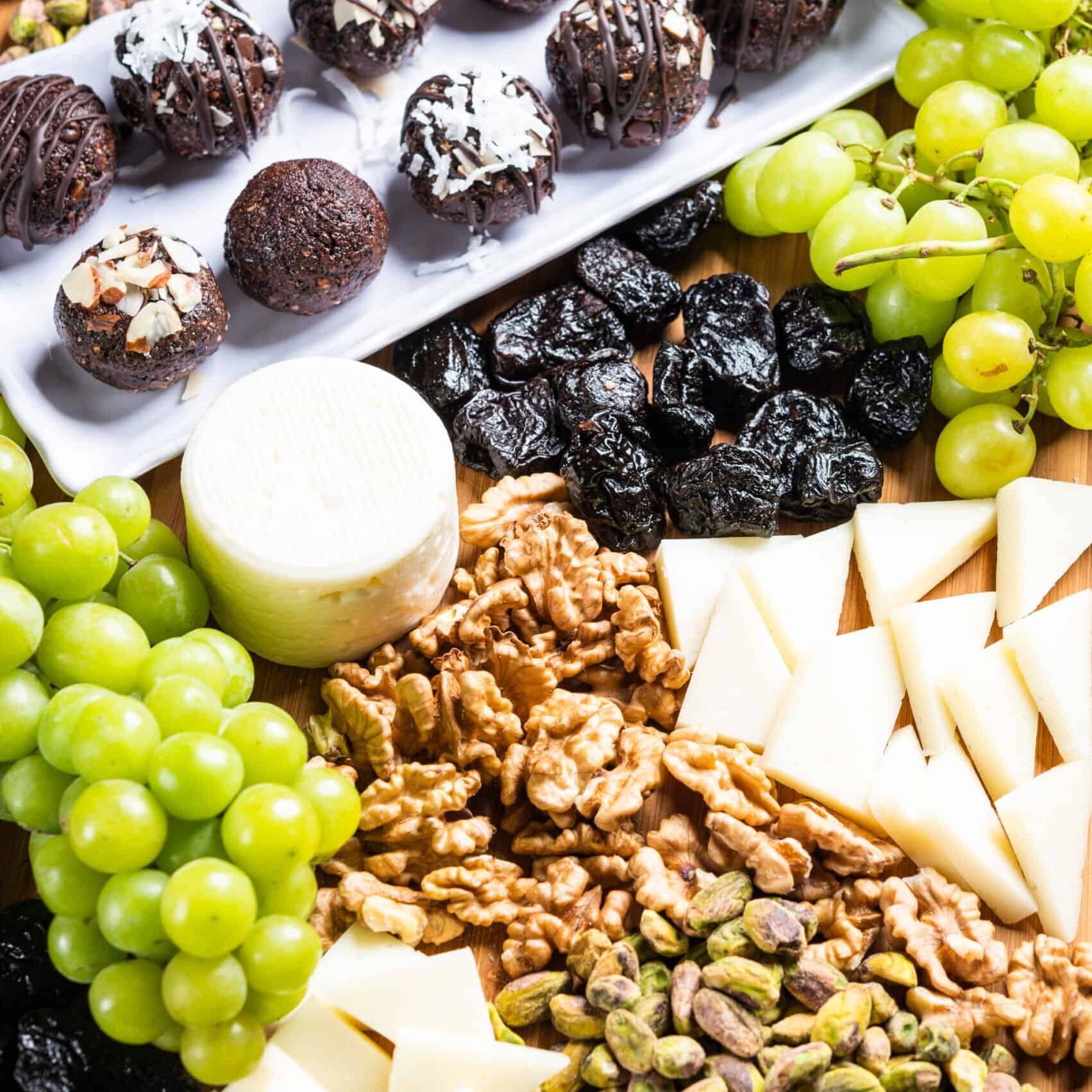 California prune snack tray with grapes, prunes, nuts and truffles