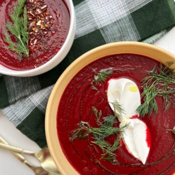 a bowl of Ukrainian Borscht topped with sour cream and dill