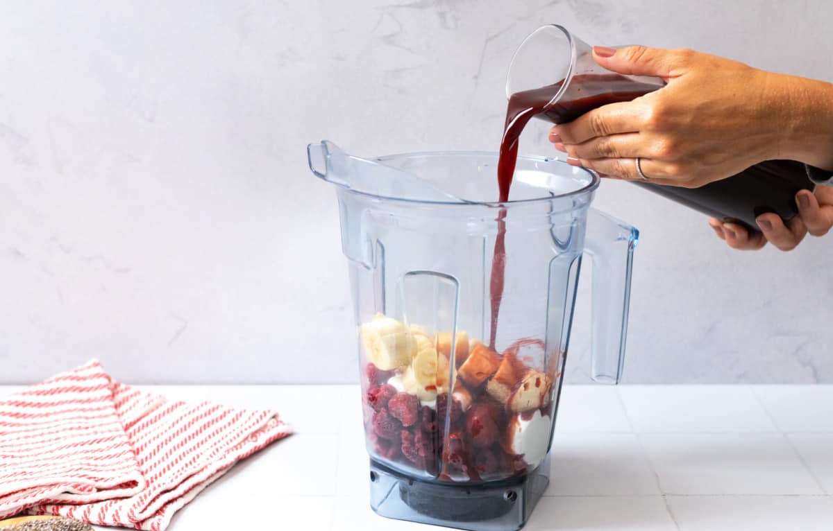 Adding Prune Juice & Smoothie ingredients to a blender for athletic performance