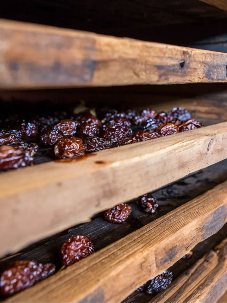prunes drying on wooden racks