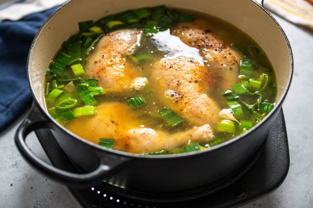 cock-a-leekie, chicken and leeks covered with broth to simmer