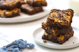 a stack of peanut butter swirl brownies on a small plate