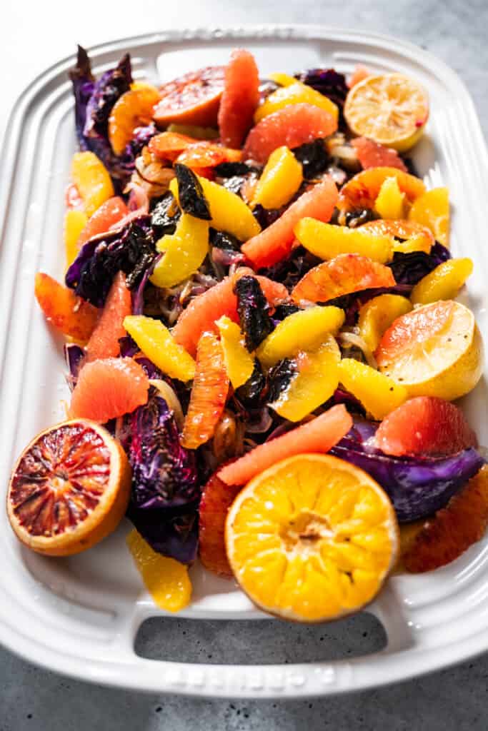 a platter of roasted cabbage with prunes and citrus