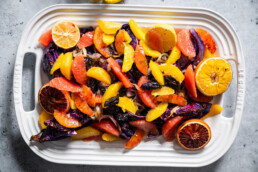a serving dish of roasted cabbage with prunes and citrus