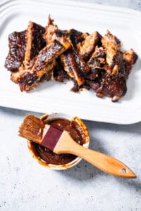 bbq sauce recipe - bbq sauce on brush with rubs in background