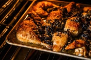 chicken marbella baking in the oven