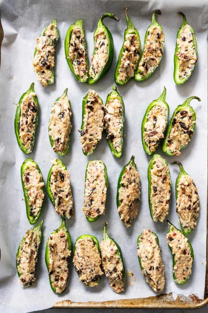 filled jalapeno peppers on a tray