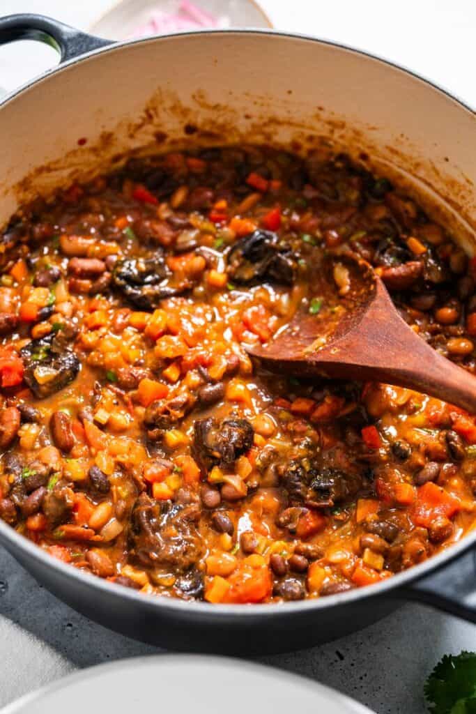 pot of vegan chili with wooden spoon