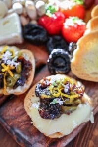 prune olive relish on crostini with brie