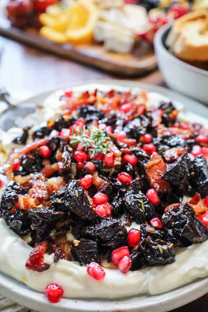 whipped ricotta topped with candied bacon, prunes and pomegranate