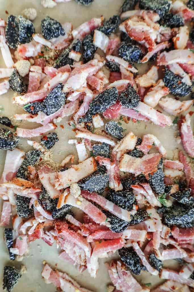 bacon and prunes with brown sugar and rosemary on a baking sheet