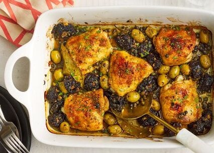 a serving plate with Reba's Chicken Thighs with Olives and Prunes