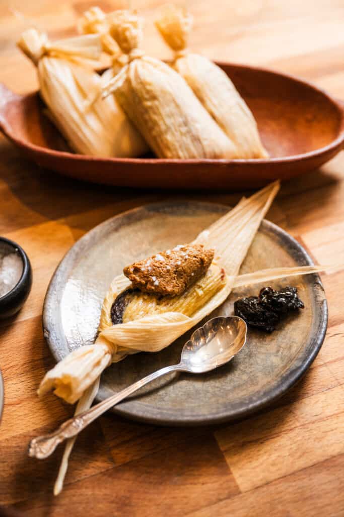 Ana Castro's Sweet Corn Tamales with Prunes and Pecans on a plate