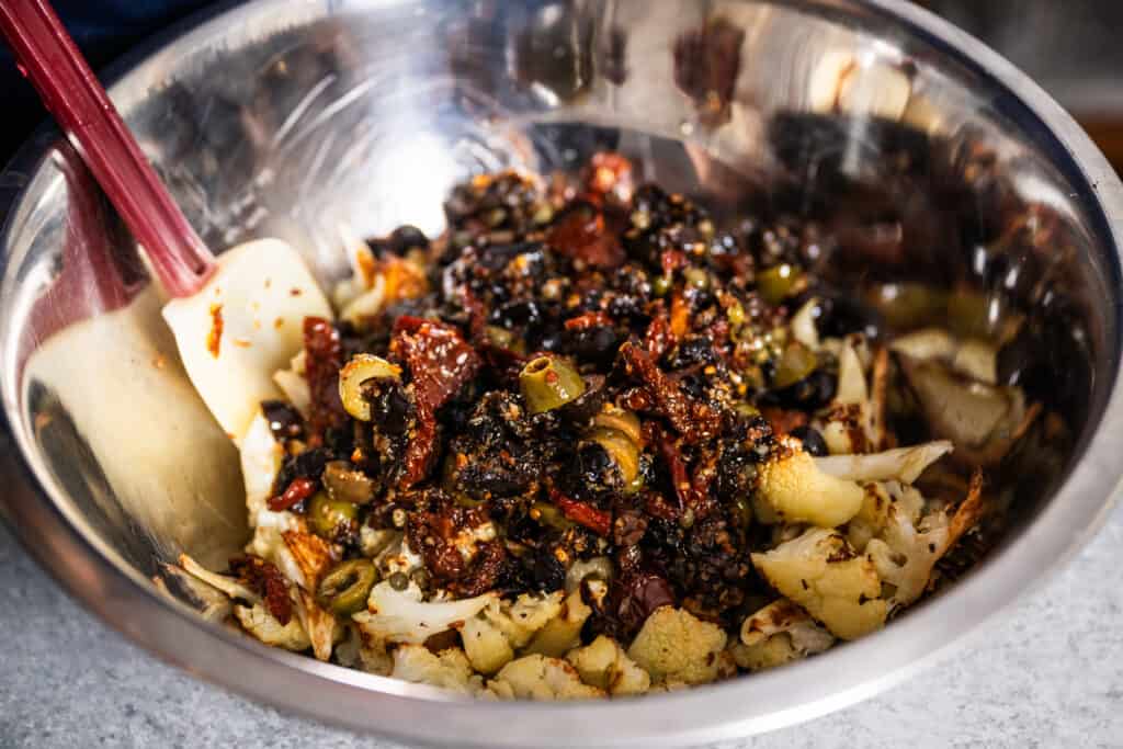 stirring ingredients into cauliflower recipe