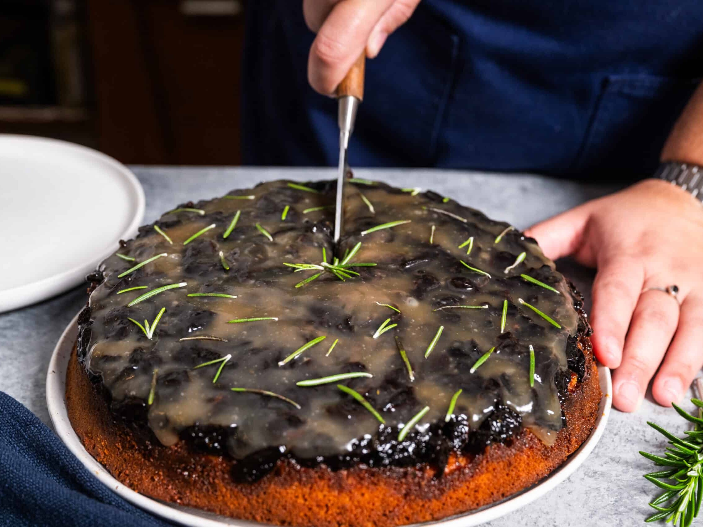 slicing gregory gourdet's ginger cake with prune and maple glaze