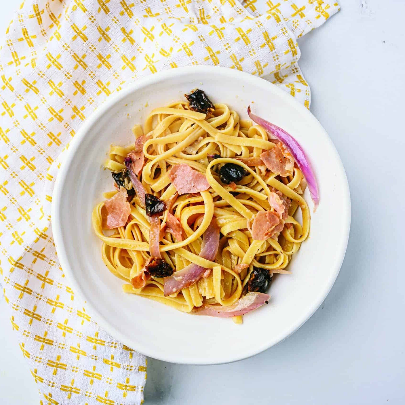 Bowl of Fettuccine with Prosciutto, Prunes and Black Pepper
