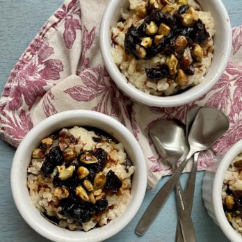 Bowls of Prune-Pomegranate Risotto Pudding with spoons