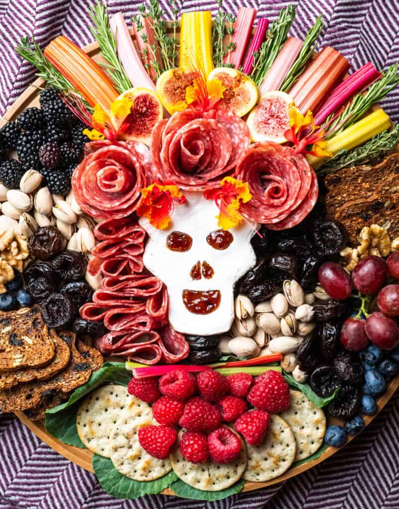 Day of the Dead Cheese Board with prunes, berries, cheese crackers and nuts