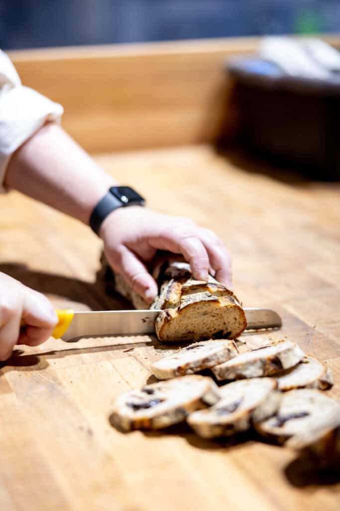 Avery Ruzicka demonstrating how to cut a prune seed loaf