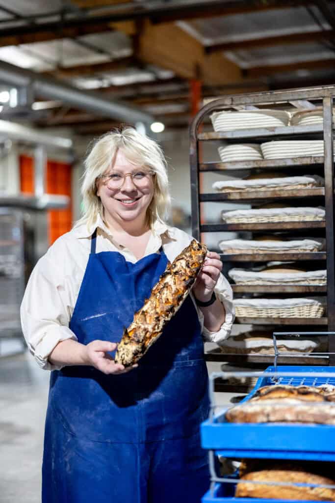 Avery proudly holding one of her prune seed baguettes