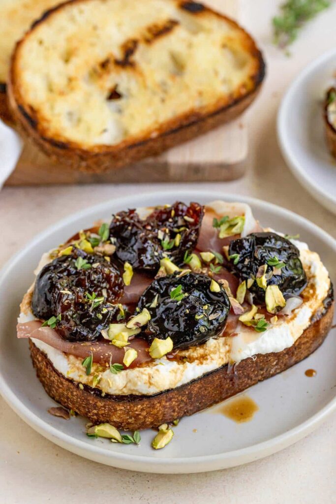 prunes on ricotta toast with proscuitto