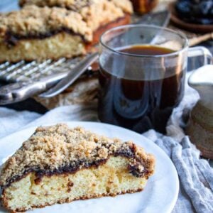 A slice of cinnamon swirl breakfast cake with a cup of coffee.