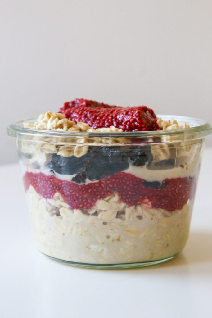 overnight oats topped with prunes and raspberry chia jam