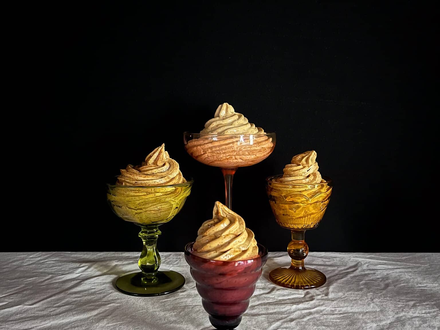 swirls of prune whip in colorful glass bowls