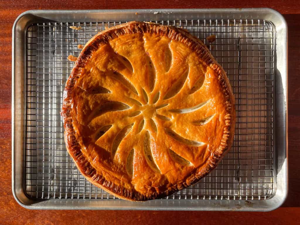 overhead shot of a galette des rois on a cooling rack