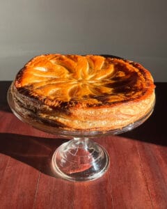 overhead shot of a galette des rois on a cake stand