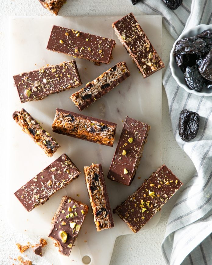 sliced oat bars covered with chocolate and chopped pistachios