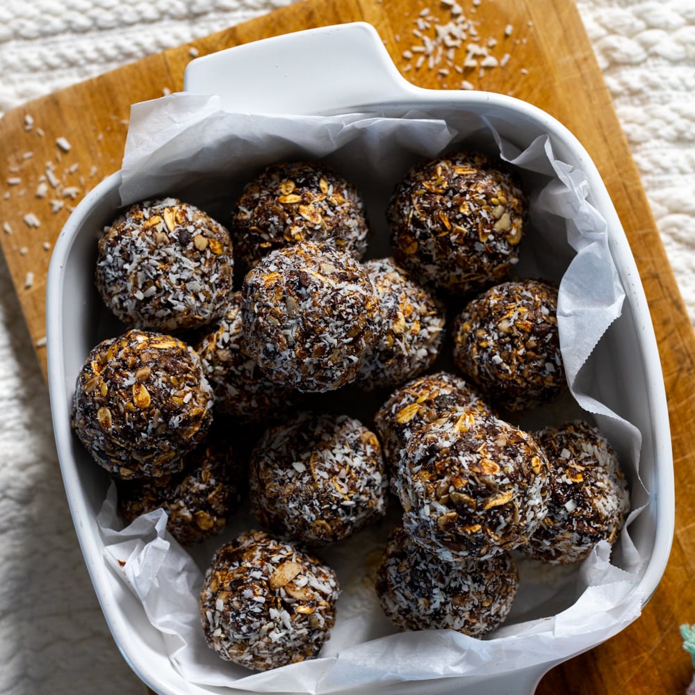 prune almond energy balls in a white pyrex dish