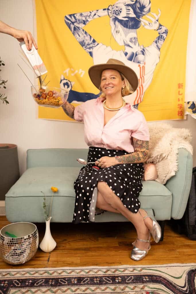 headshot of chef stephanie cmar sitting on a blue chair