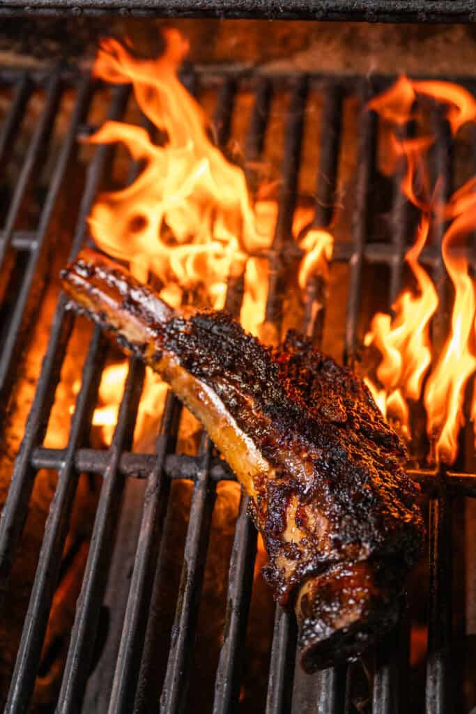 beef ribs on a grill with fire