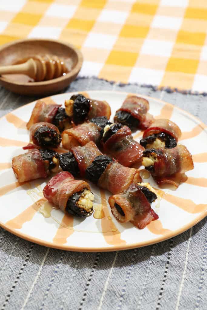 drunken prunes on a yellow and white striped plate