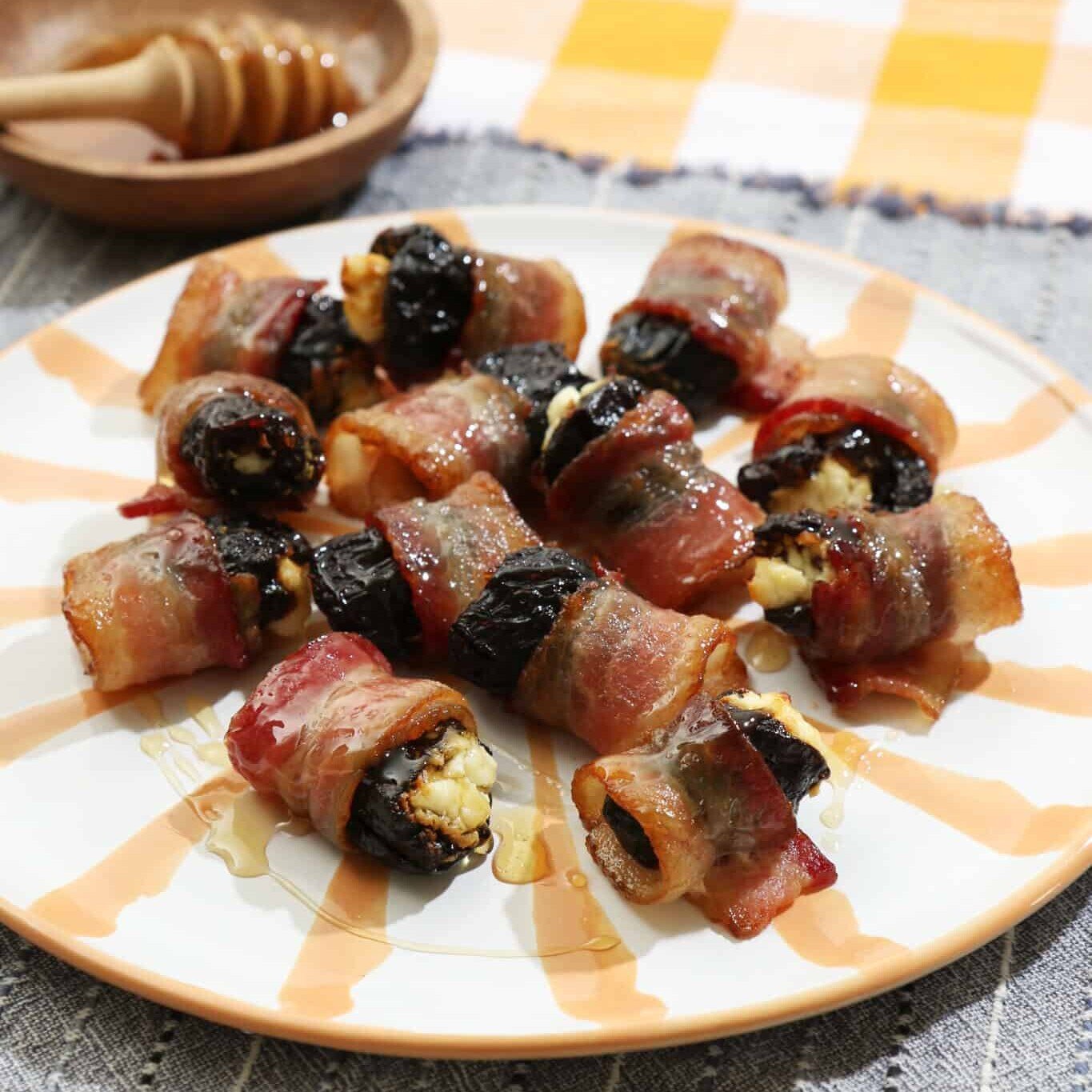 drunken prunes on a yellow and white striped plate