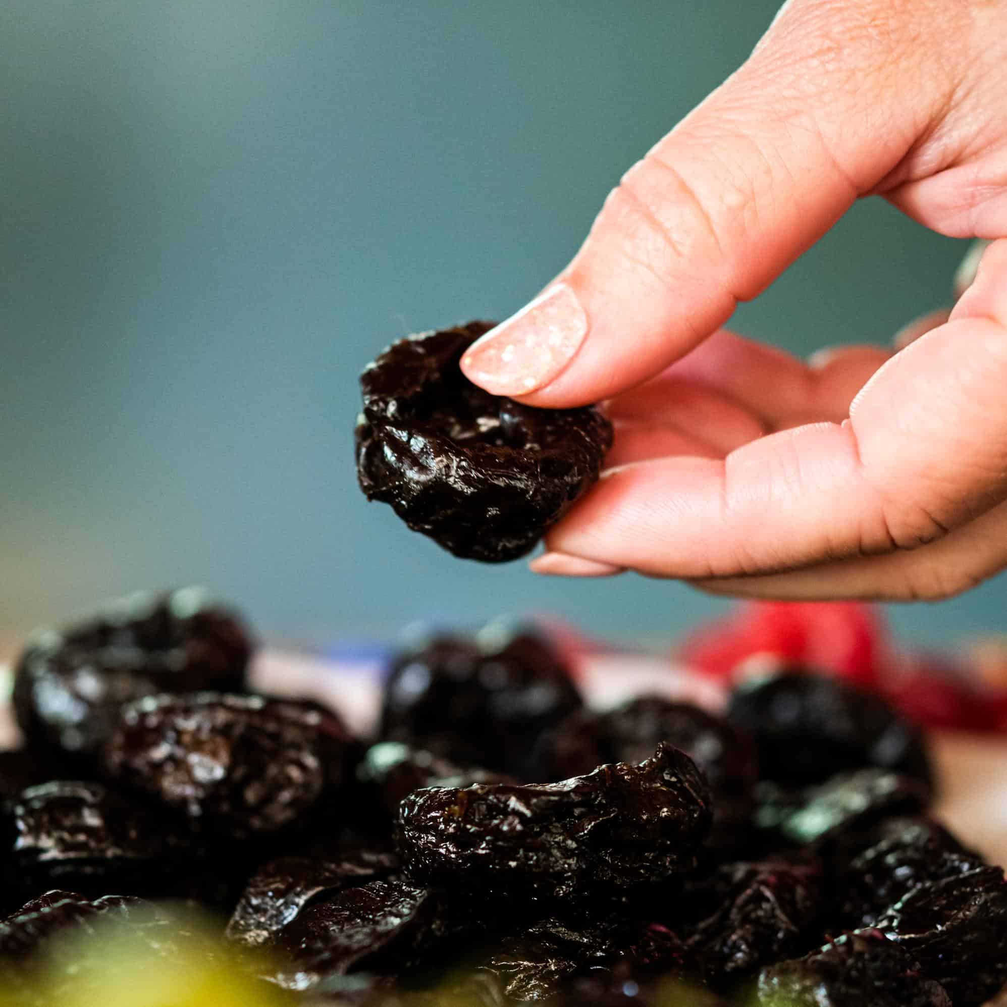 woman holding prune