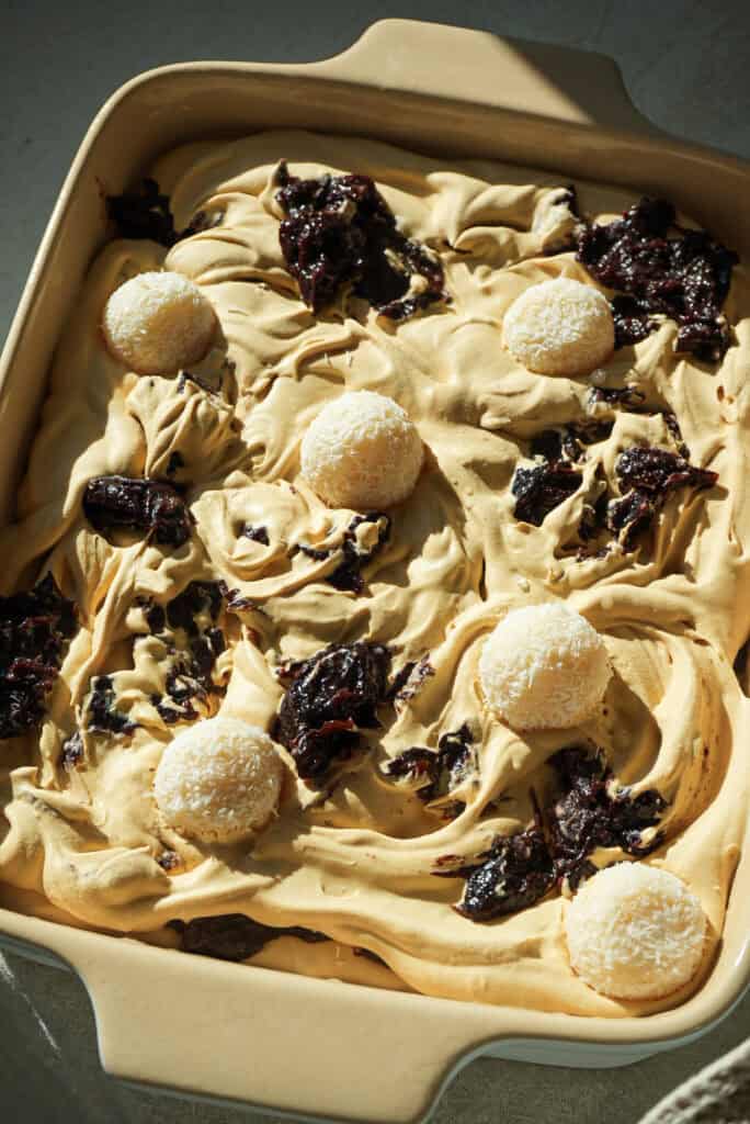 dulce de leche no churn ice cream in a dish topped with Beijinho Fudge Balls