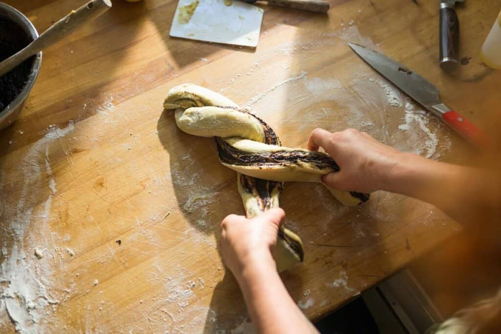 woman twisting dough into a loaf shape
