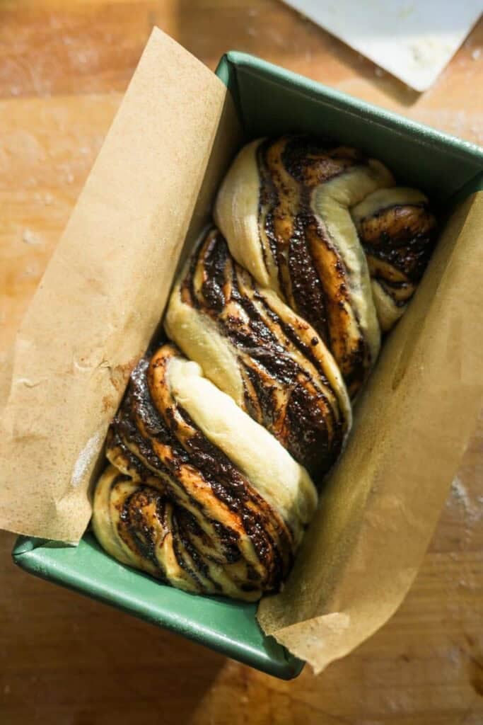 babka loaf in a lined loaf pan to rise