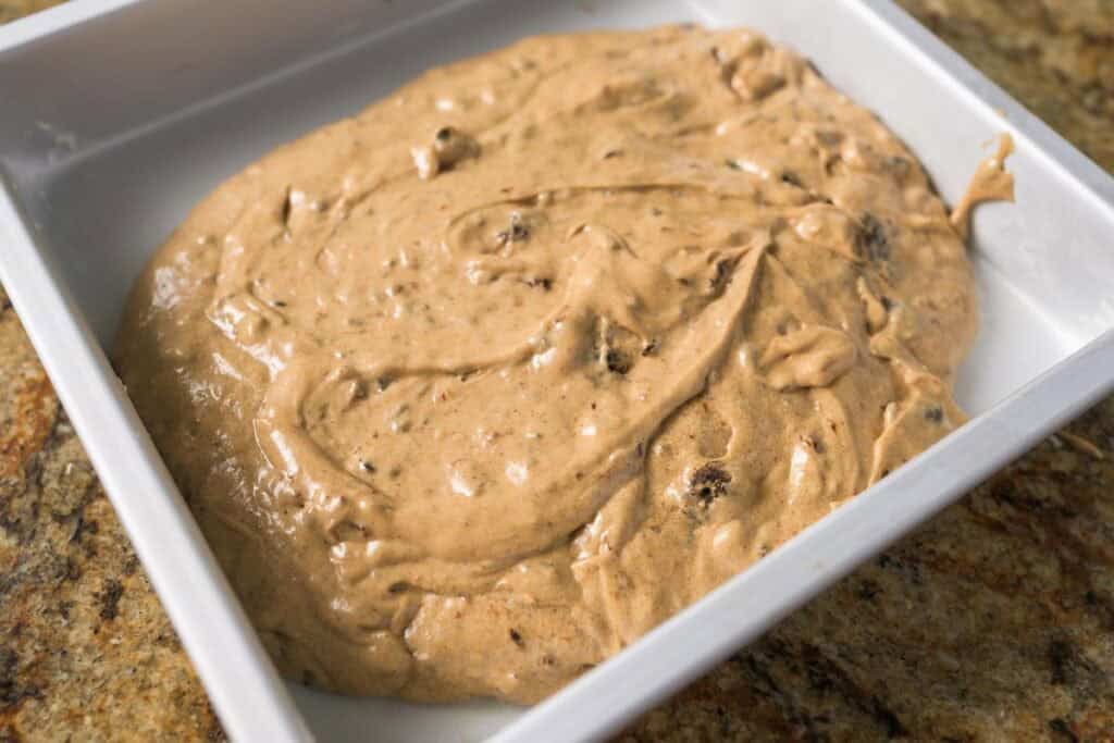 batter for old school prune spice cake in a white baking dish