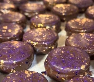 chocolate glazed sandwich cookies on a tray
