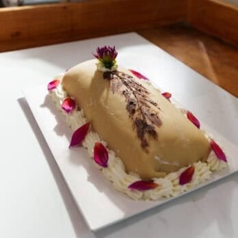 Goose breast cake on a white platter