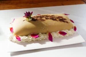 Goose breast cake on a white platter