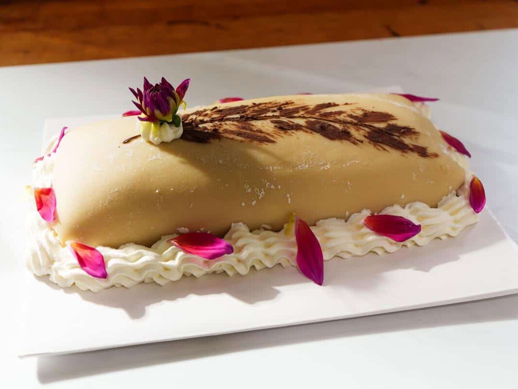 Goose breast cake on a white platter
