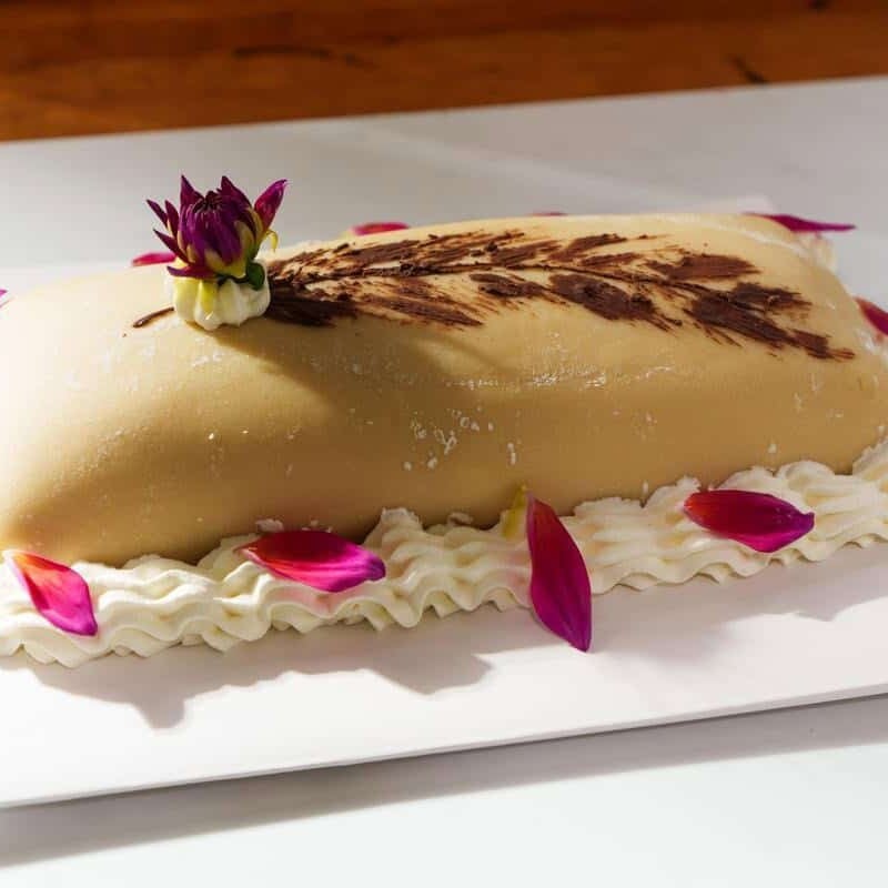 Goose breast cake on a white platter