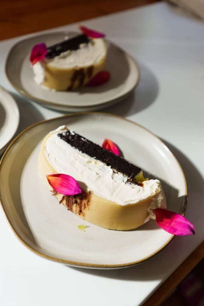 slices of goose breast cake on white plates