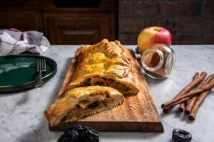 prune apple strudel on a wooden board