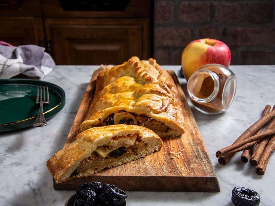 prune apple strudel on a wooden board